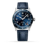 The Longines Spirit Zulu Time features a blue dial, stainless steel case, silver accents, white indices, and a blue leather strap. The automatic watch displays 10:10 and the date is set to the 25th.