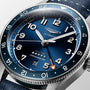 Close-up of the Longines Spirit Zulu Time wristwatch featuring a blue dial, blue ceramic bezel, silver hour markers, a 6 o’clock date window, and an orange-tipped GMT hand in a stainless steel case.