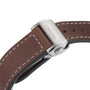 Close-up of a brown leather strap with white stitching and stainless steel clasp engraved with Longines, inspired by exploration and the legacy of the Spirit Zulu Time collection.