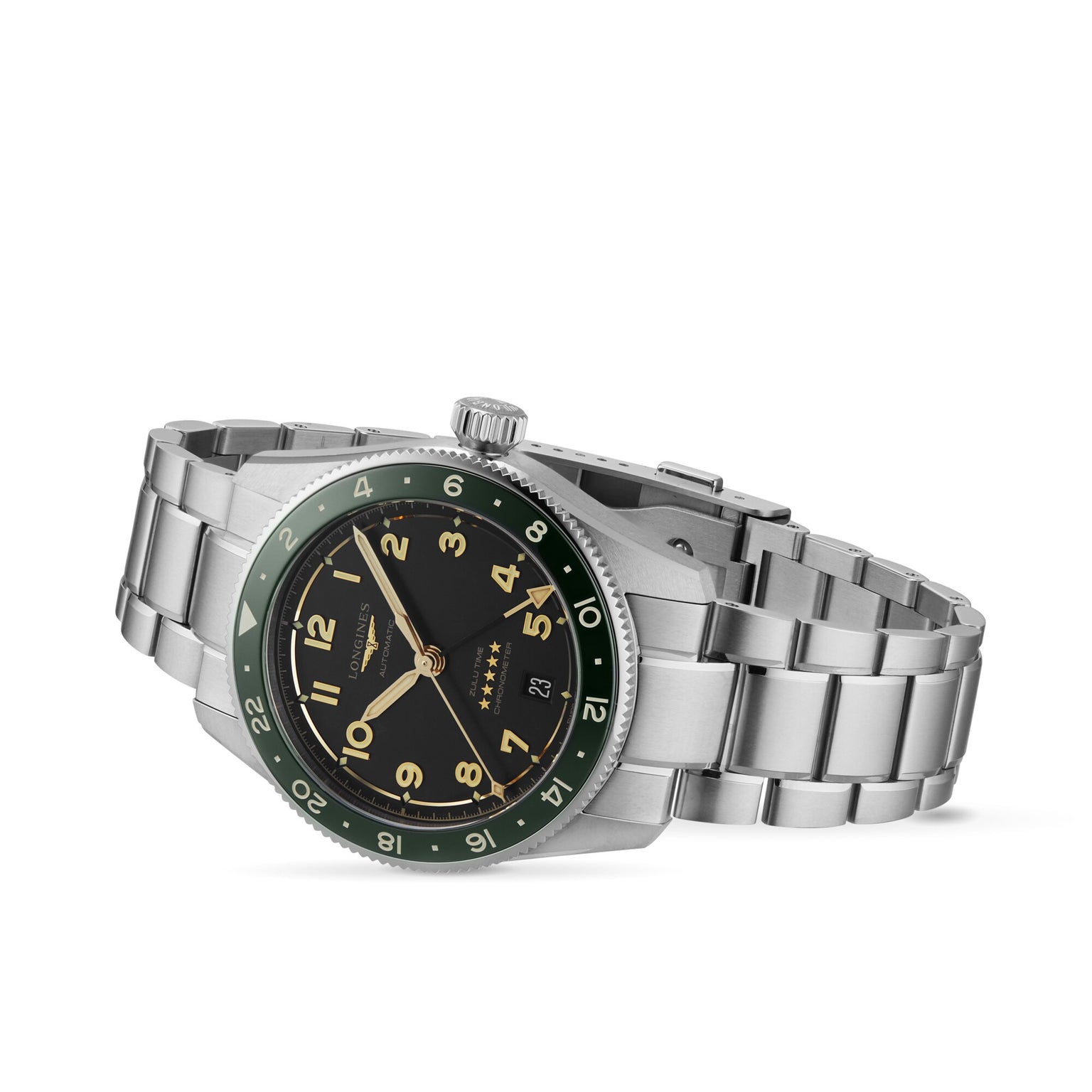 The Longines Spirit Zulu Time wristwatch features a stainless steel case, black dial with Arabic numerals, date window, green ceramic and black bezel, and metal link bracelet, displayed at an angle on a white background.