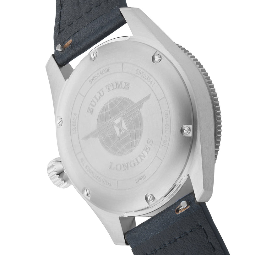 The image displays the back of the Longines Spirit Zulu Time watch, featuring a stainless steel case, engraved globe, ZULU TIME and LONGINES inscriptions, and a black leather strap—emphasizing its multi-time zone functionality.