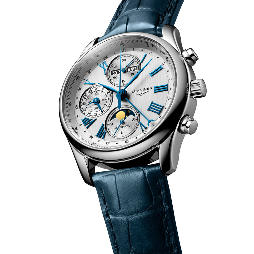 The Longines Master Collection Chrono Moonphase is a silver analog watch with a blue leather strap, white face, three chronographs, Roman numerals, and displays for date, day, and moon phase.