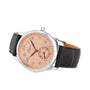 The Longines Master Collection wristwatch features a salmon pink dial with black Arabic numerals, small seconds subdial, self-winding movement, black leather strap, and a sleek silver case.