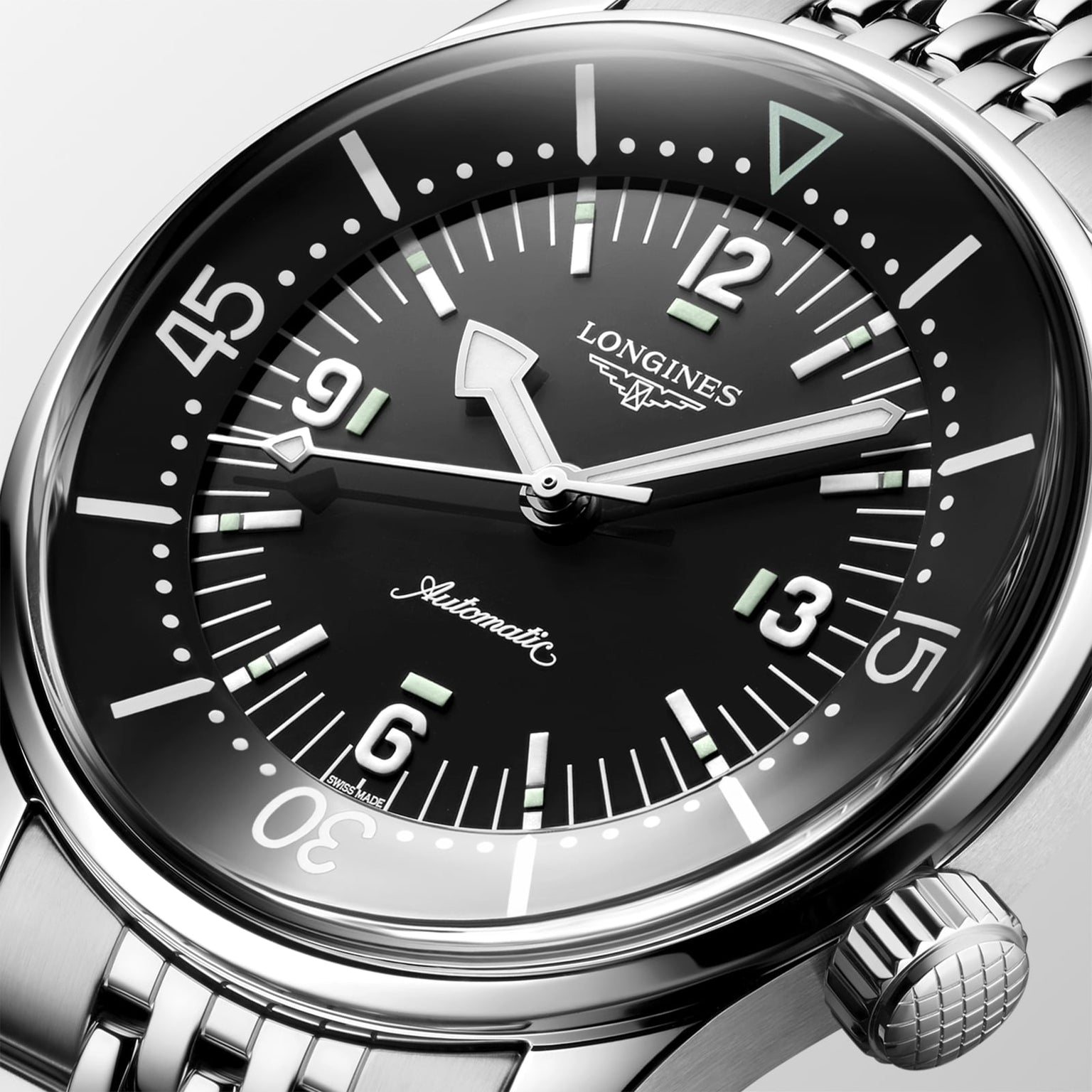 Close-up of the Longines Legend Diver watch with automatic movement, black dial, Arabic numerals, luminous markers, and a stainless steel bracelet.