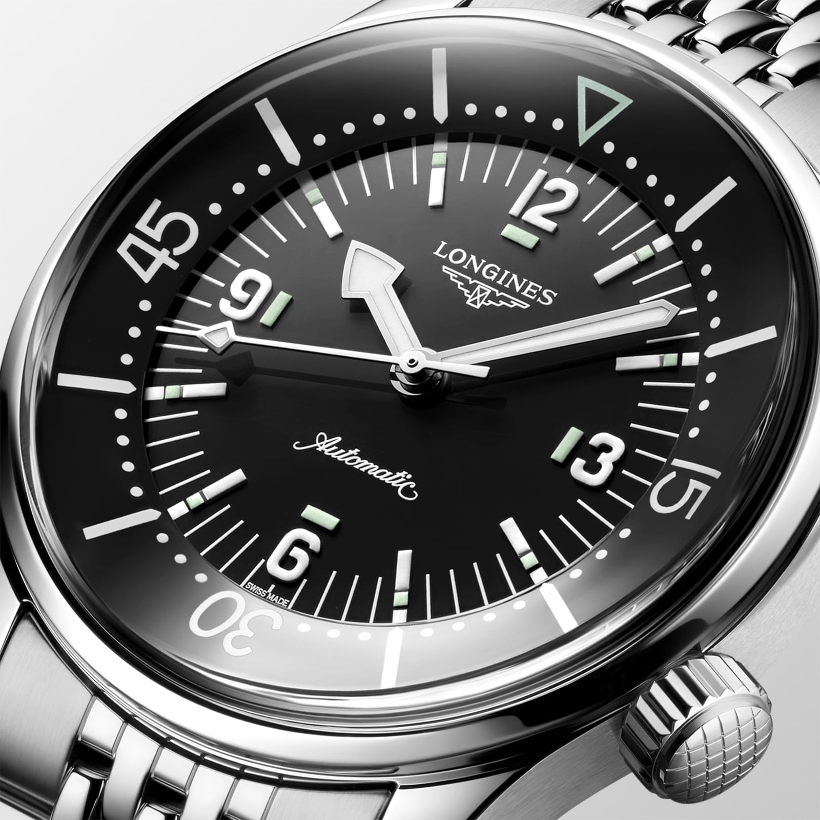 Close-up of the Longines Legend Diver watch with automatic movement, black dial, Arabic numerals, luminous markers, and a stainless steel bracelet.