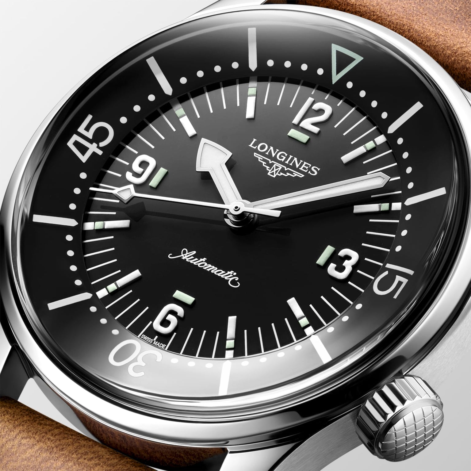 Close-up of the Longines Legend Diver, a vintage-inspired automatic watch with black dial, white numerals, luminous markers, and brown leather strap.