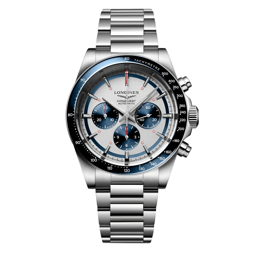 The Longines Conquest Chronograph features a stainless steel case, silver and blue dial with three subdials, tachymeter bezel, metal link bracelet, and is powered by an automatic movement.