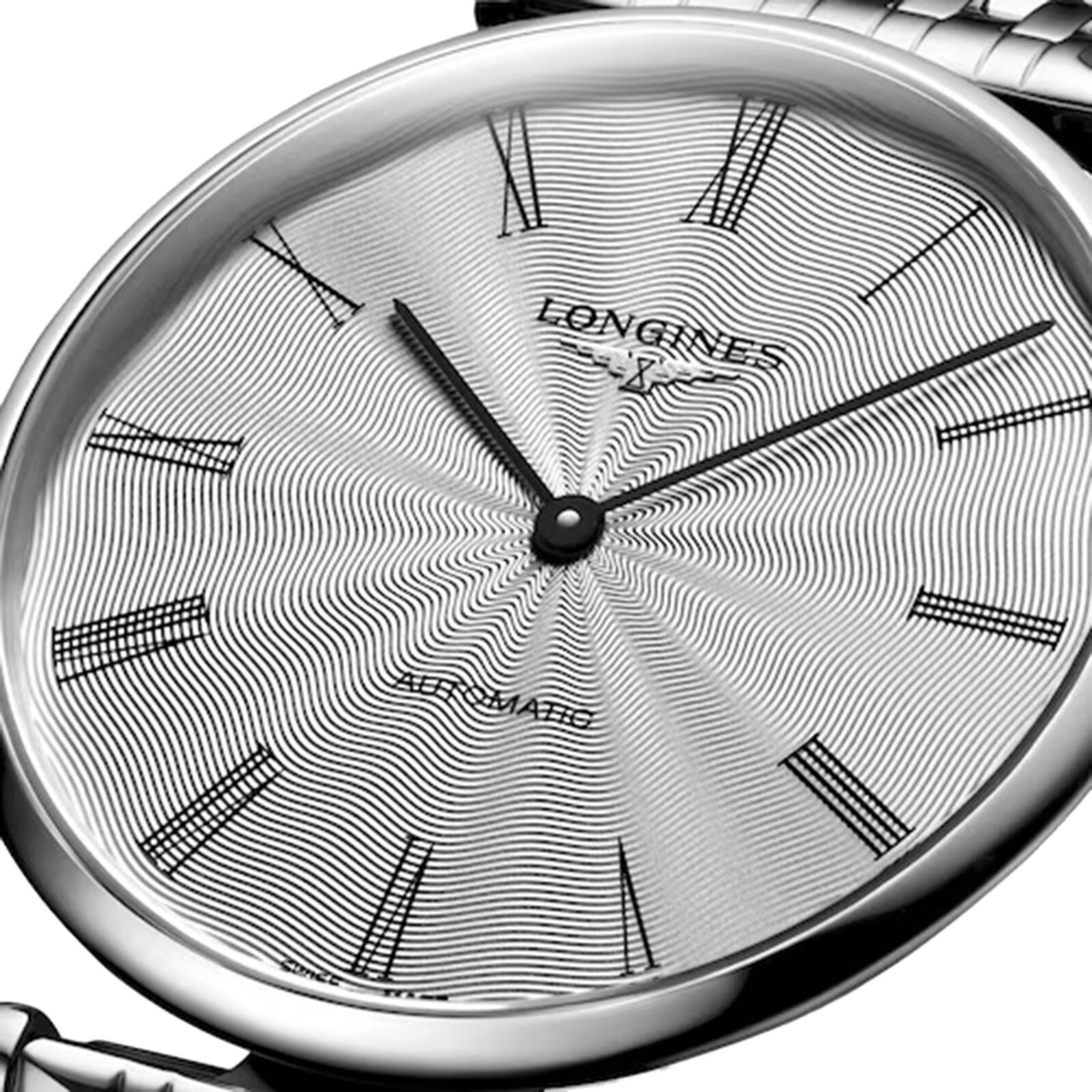 Close-up of a silver Longines La Grande Classique de LONGINES wristwatch with a patterned dial, Roman numerals, and black hands, displaying 2:07 in elegant style.