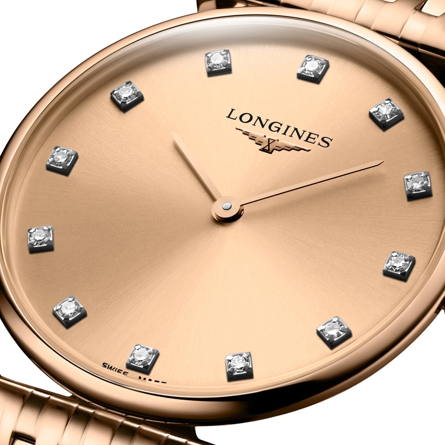 Close-up of the La Grande Classique de LONGINES by Longines, a gold wristwatch with diamond hour markers and two gold hands, showing 10:10.