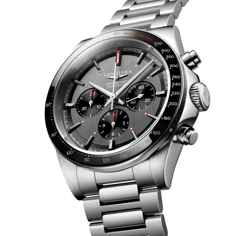 The Longines Conquest Chrono Ski Edition is shown at an angle, featuring a silver stainless steel bracelet, black dial with three sub-dials, and tachymeter scale—highlighting the Swiss watchs accuracy and elegant design.