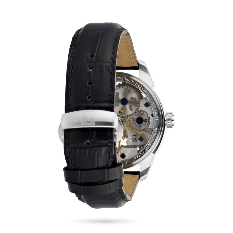 The Tissot T-Complication Squelette Mechanical is a wristwatch with a black leather strap, stainless steel buckle, and a transparent back displaying its intricate skeleton movement and visible gears.