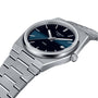 The Tissot PRX is a stainless steel wristwatch featuring a blue to black gradient dial, silver hour markers, date display, 1970s-inspired design, and Swiss quartz movement.