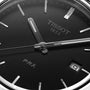 Close-up of a Tissot PRX watch face displaying the time at 6:08 and the date as the 9th.
