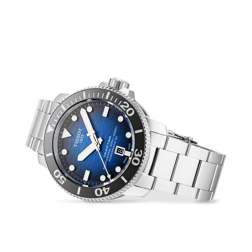 The Tissot Seastar 2000 Professional Powermatic 80 is a stainless steel wristwatch with a blue dial, white markers, date display, and black bezel, shown angled on a white background. Powered by the Powermatic 80 movement.