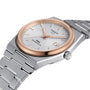 The Tissot PRX Powermatic 80 wristwatch gleams on its stainless steel bracelet, featuring a textured white dial, gold bezel, and date display—exemplifying the refined design of Tissot timepieces.