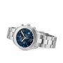 The Tissot PR 100 Sport Chic Chronograph, featuring a silver metal bracelet, blue dial, three subdials, and date display, is shown at an angle.