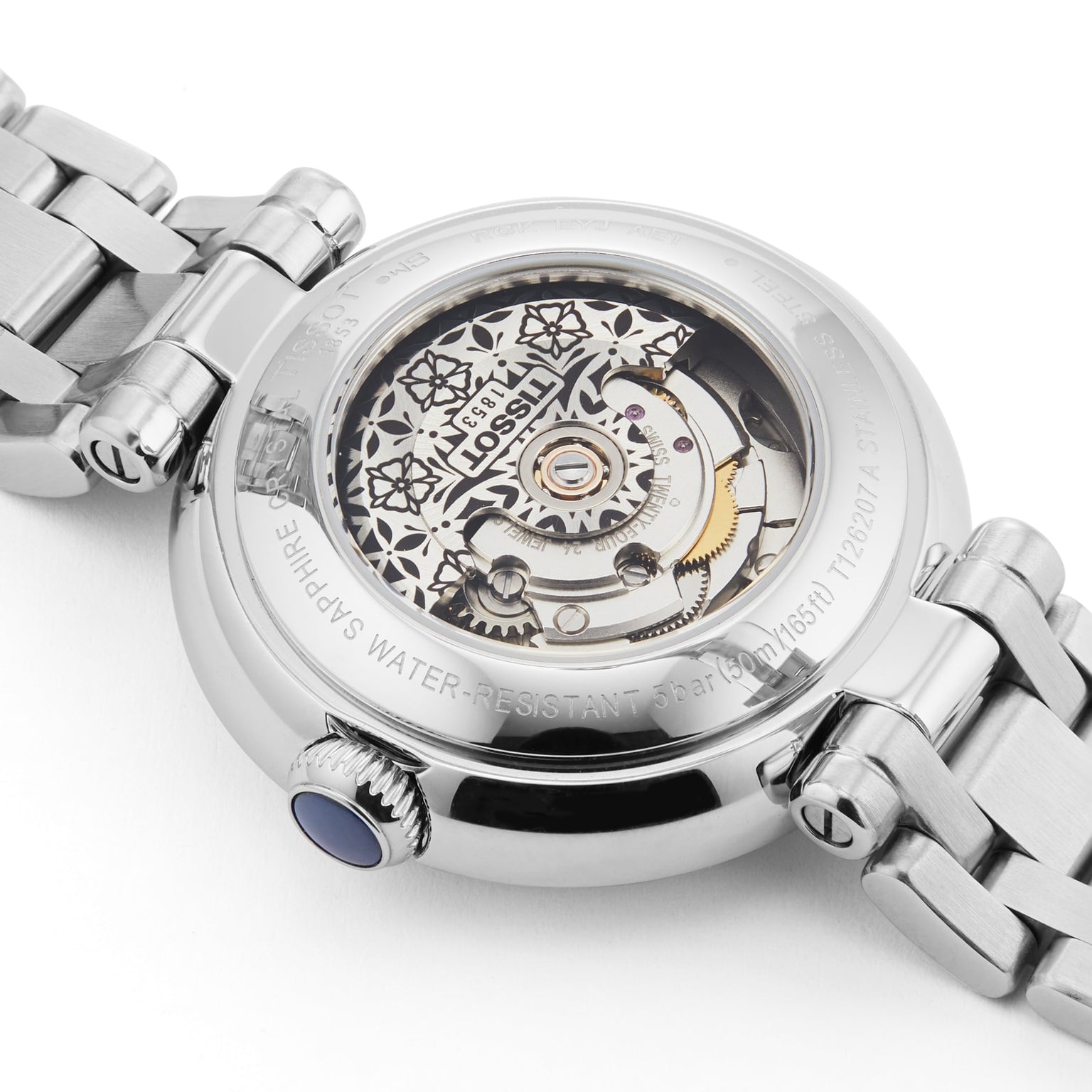 Close-up of the back of the Tissot Bellissima Automatic wristwatch, featuring a transparent case that reveals the intricate Swiss movement and metal bracelet.