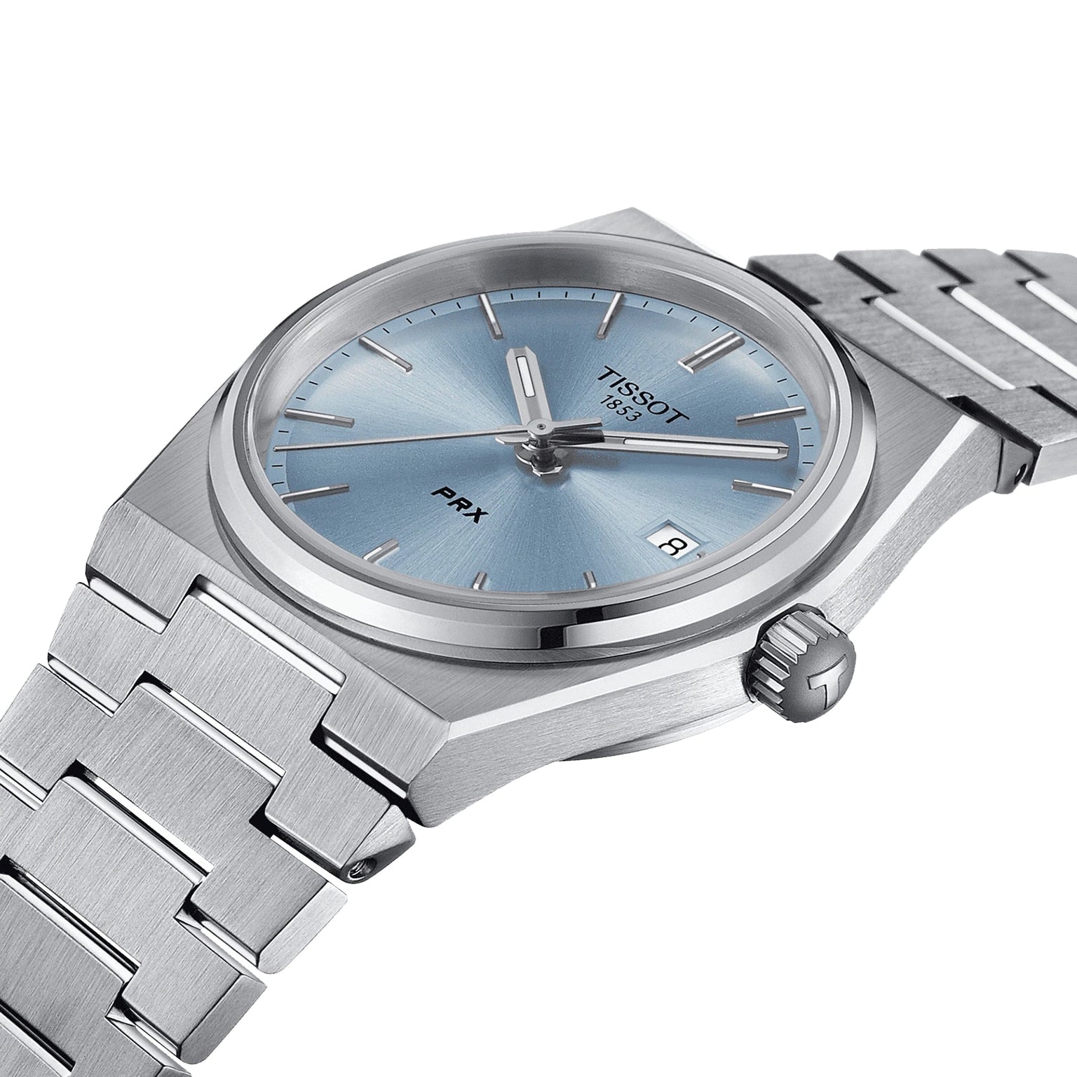 The Tissot PRX features a stainless steel case, blue dial, silver markers, and a date at 3 o’clock. Shown at an angle, it showcases its 1970s-inspired design and Swiss quartz precision.