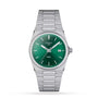 The Tissot PRX is a stainless steel wristwatch featuring a green dial, Swiss quartz movement, date display at 3 oclock, and a silver metal bracelet, displayed on a white background.