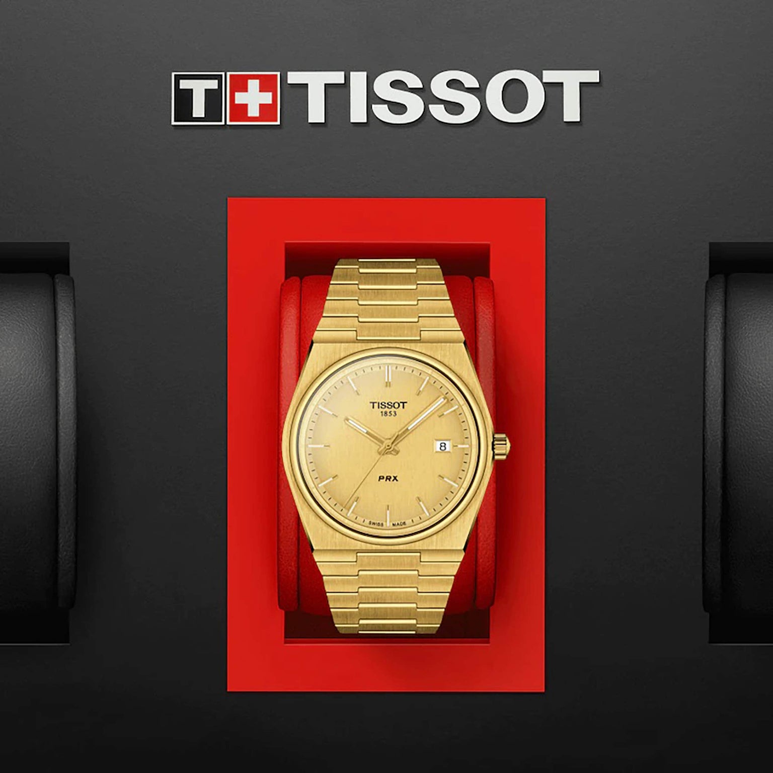 A Tissot PRX gold wristwatch with a stainless steel case is showcased in a red box beneath the Tissot logo on a black background.