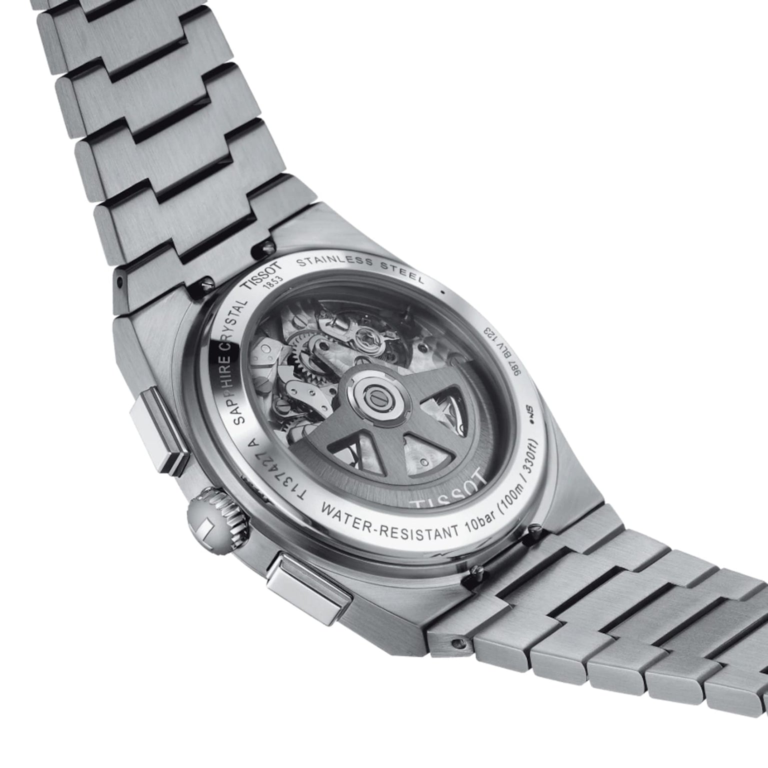 The Tissot PRX Automatic Chronograph features a stainless steel band, a transparent case back revealing the Swiss automatic movement, and a 70s-inspired design.