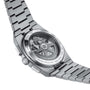 The Tissot PRX Automatic Chronograph features a stainless steel band, a transparent case back revealing the Swiss automatic movement, and a 70s-inspired design.