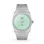 A stainless steel Tissot PRX wristwatch features a mint green dial, silver hour markers, date display at 3 o’clock, and “Tissot 1853” on the face, showcasing classic design.