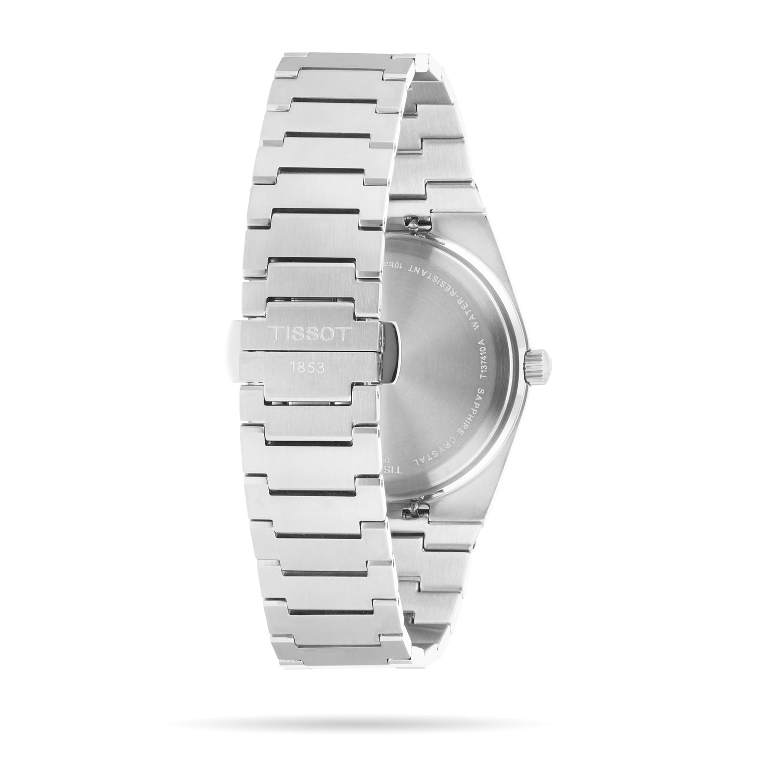 The image displays the back view of the Tissot PRX, featuring a stainless steel bracelet and a clasp engraved with TISSOT 1853, emphasizing the watchs refined case back and craftsmanship.