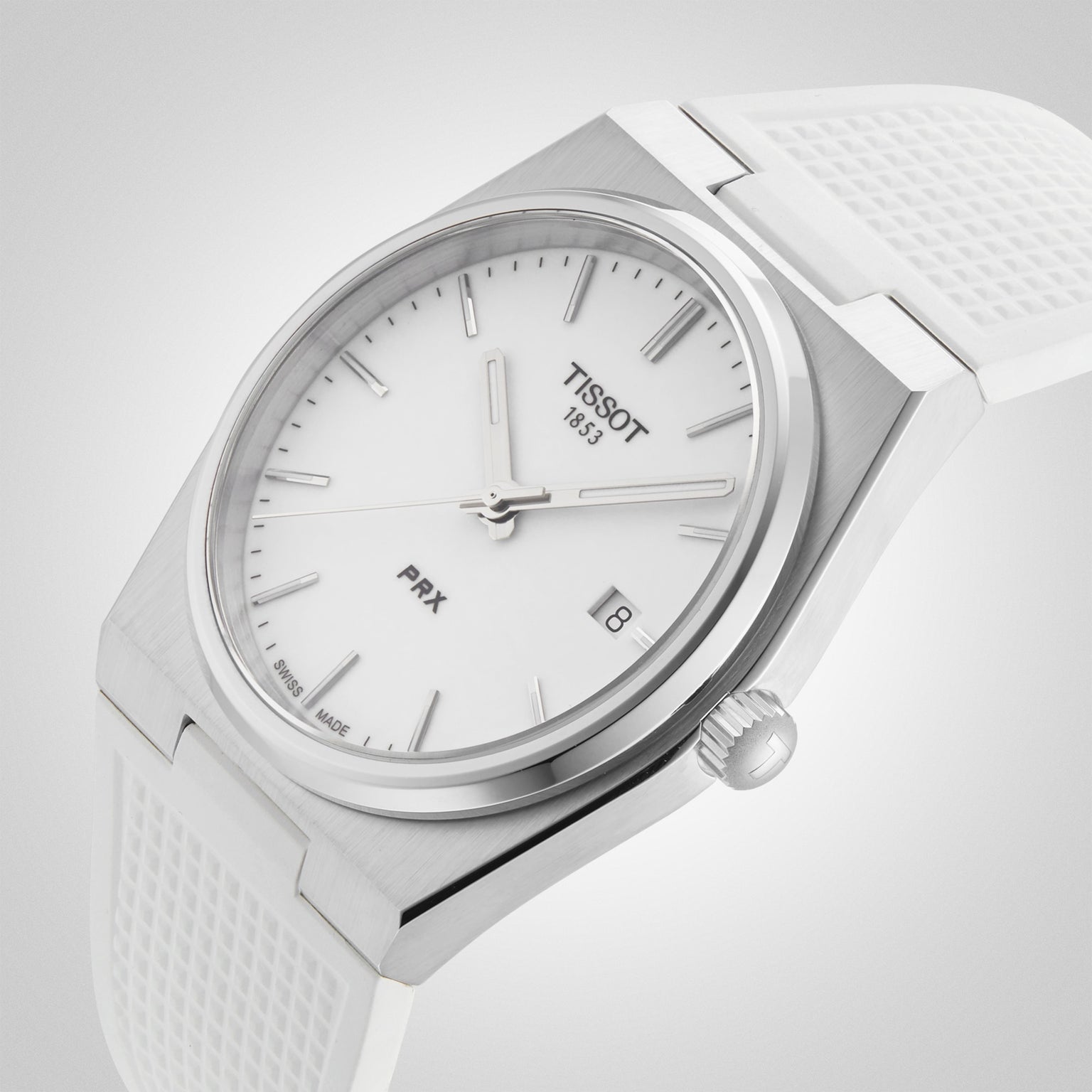 Close-up of the Tissot PRX wristwatch featuring a white dial, silver markers, and a white textured strap.