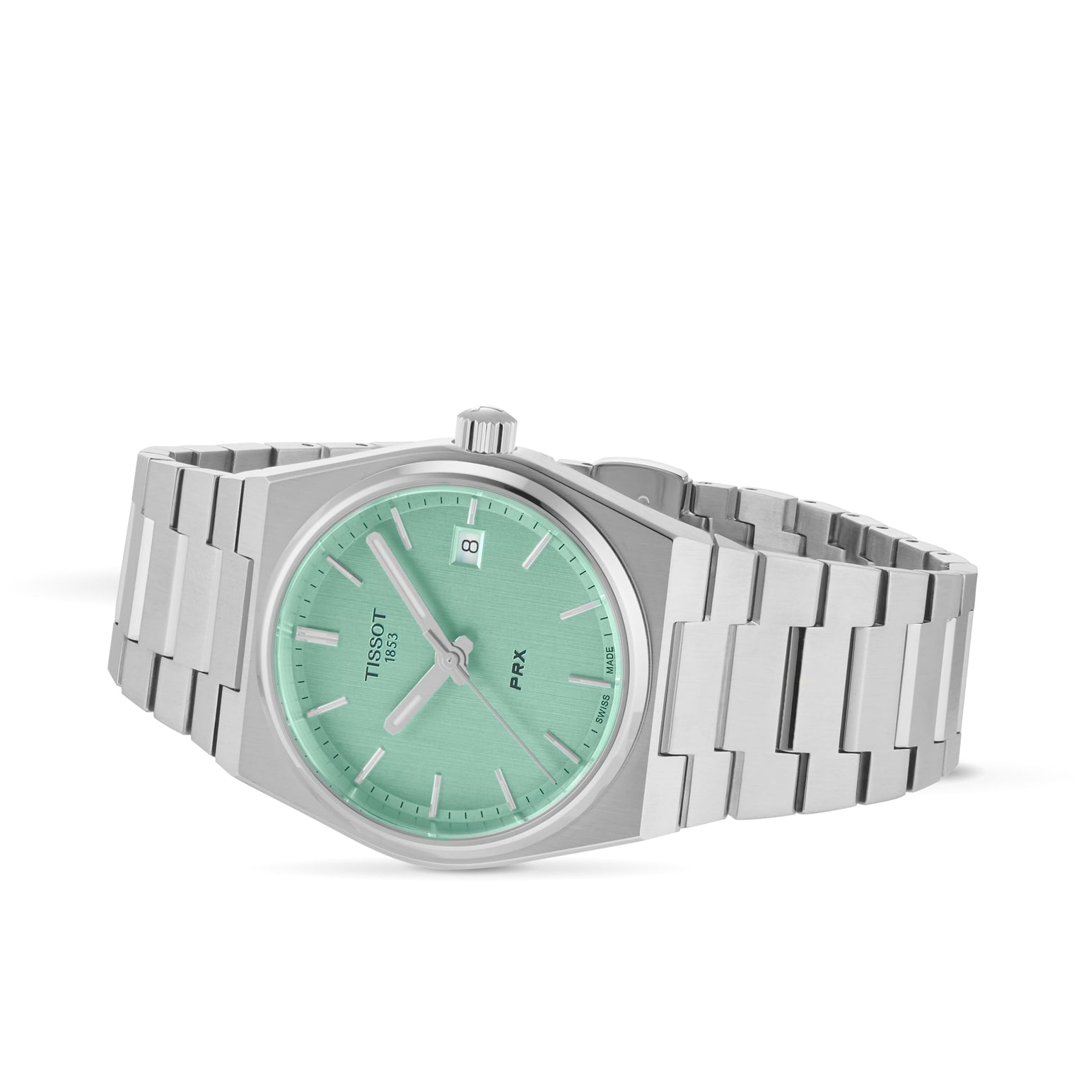 The Tissot PRX is a silver retro watch with a mint green dial, silver hour markers, a date window at 3 o’clock, and a stainless steel bracelet, shown elegantly on a white background.