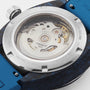 Close-up of the back of the Tissot Sideral S Powermatic 80, featuring a transparent case displaying its automatic movement and a blue strap.
