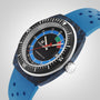 The Tissot Sideral S Powermatic 80 dive watch features a blue perforated strap, black rotating bezel, and multicolored dial, shown against a light gray background.