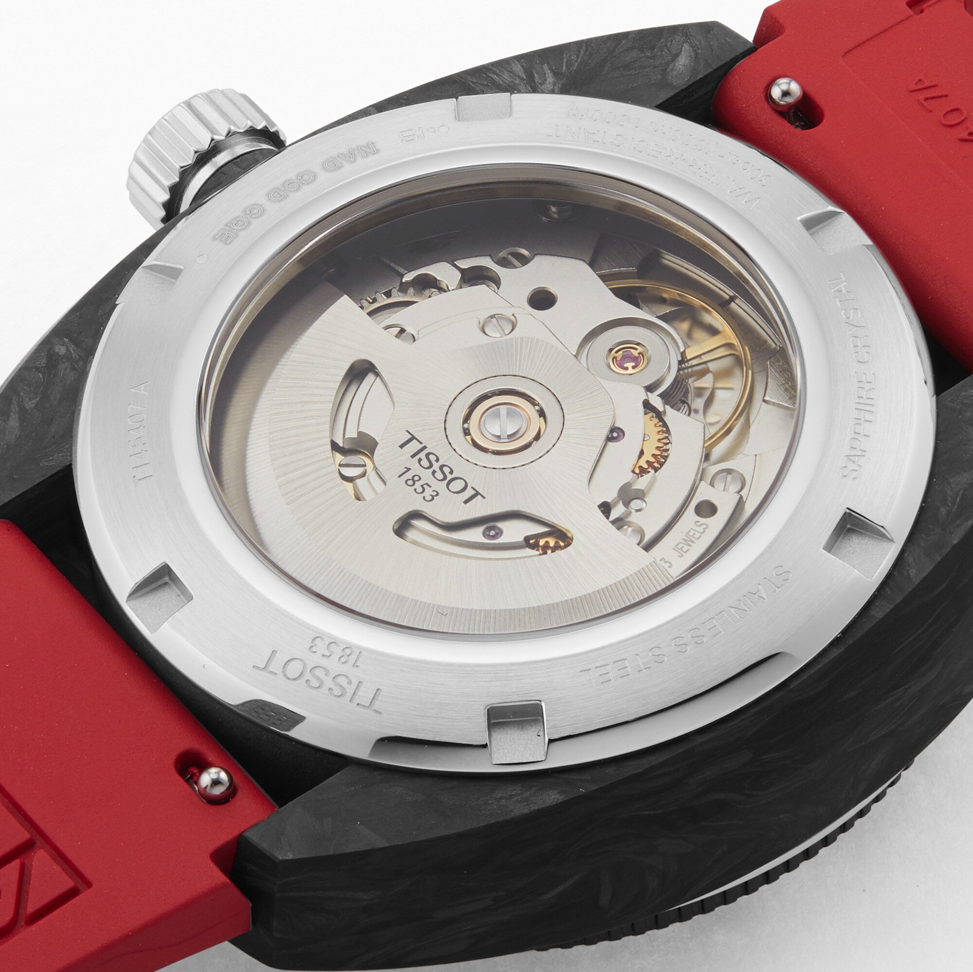 Close-up of the back of the Tissot Sideral S Powermatic 80, showing its exposed mechanical movement through a transparent caseback and featuring a red rubber strap.