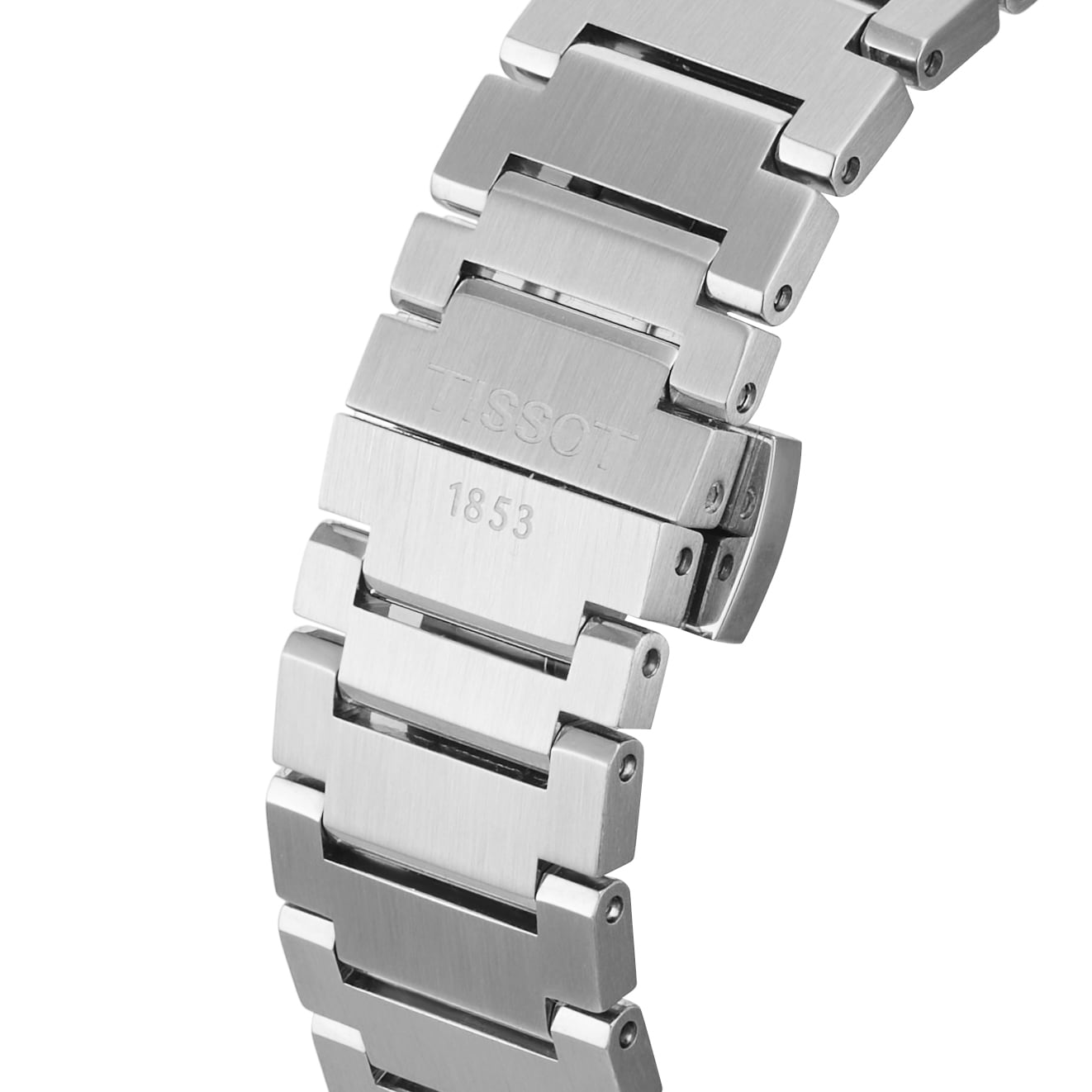 Close-up of a stainless steel bracelet with Tissot 1853 on the clasp, highlighting the elegant Tissot PRX Powermatic 80 with a striking green dial.