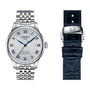 The Tissot Le Locle Powermatic 80 20th Anniversary wristwatch features a silver metal bracelet, white dial with blue Roman numerals, automatic movement, date display, and includes an extra black leather strap with a metal clasp.