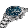 A Tissot PR516 Chronograph with a silver metal bracelet and blue dial, viewed from an angle.