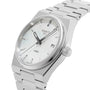 The Tissot PRX watch features a stainless steel bracelet, white dial, date display, and baton hour markers—displayed at an angle.