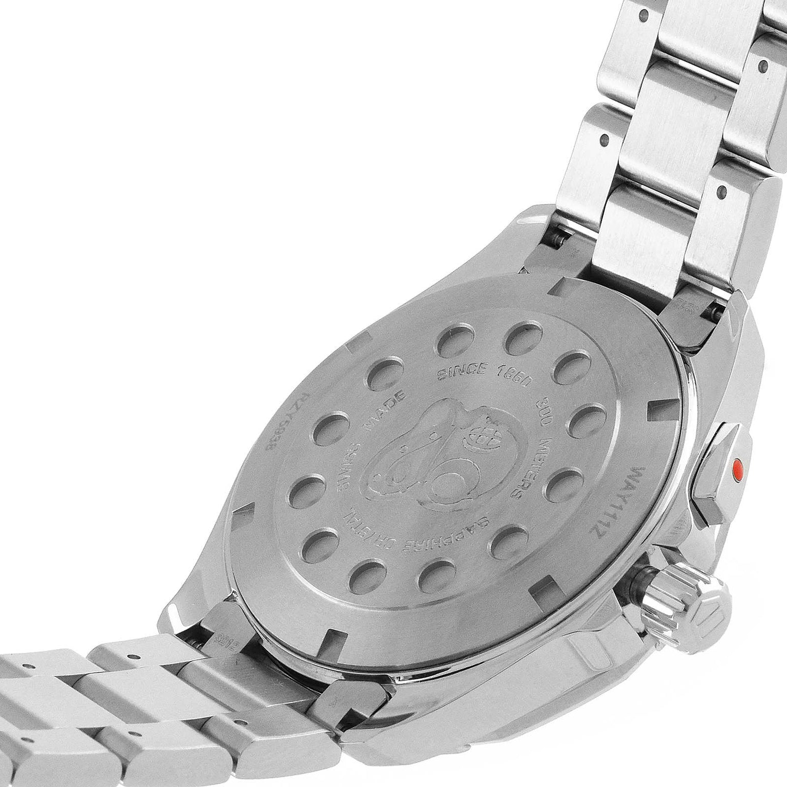 Close-up of the back of a TAG Heuer Aquaracer stainless steel sports watch with engraved text and circular details, showing part of the metal bracelet and clasp.