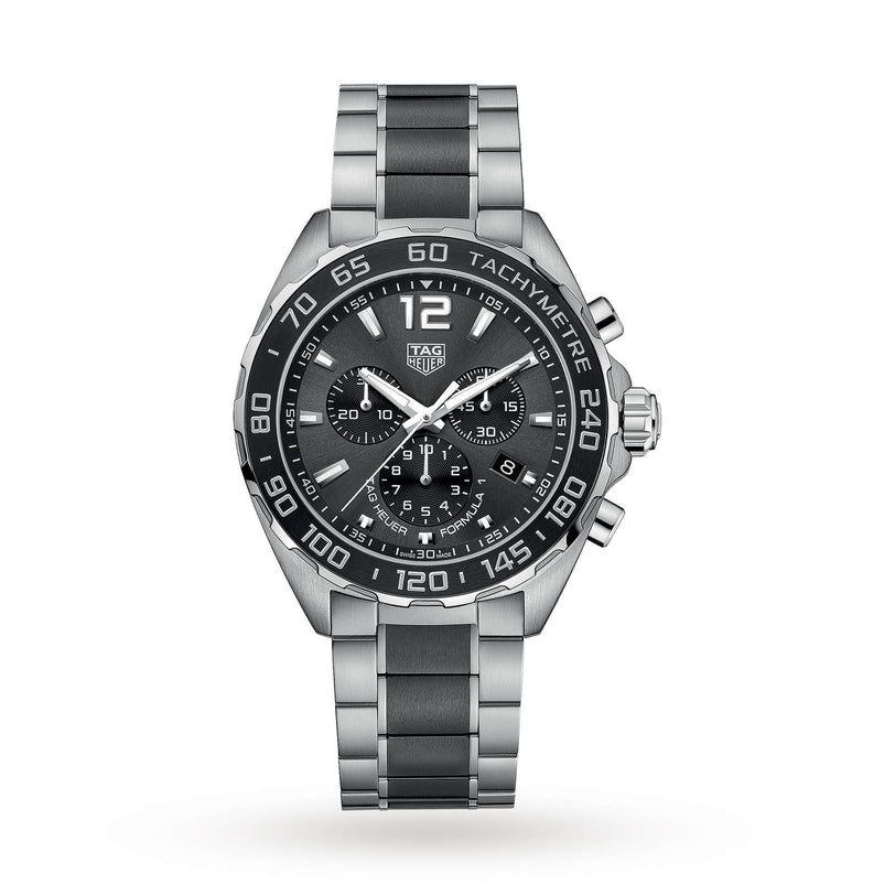 The TAG Heuer Formula 1 Chronograph features a stainless steel case, black dial with three subdials, black tachymeter bezel, and metal bracelet, highlighting its motor-racing inspired design against a white background.
