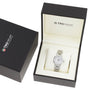 A TAG Heuer Link Date silver wristwatch with a mother-of-pearl dial is shown in an open branded box beside its black outer packaging.