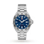 The TAG Heuer Formula 1 Date watch features a stainless steel case, blue dial, silver hour markers, date display at 3 o’clock, and a matching silver metal bracelet.