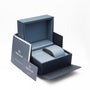 A partially open TAG Heuer Aquaracer Date watch box with branded documents and a card beside it. Inside is a cushioned holder, ideal for your sports watch or a model with a mother-of-pearl dial.