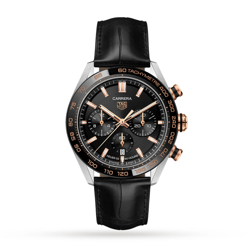 The TAG Heuer Carrera Chronograph features a black dial, gold-tone accents, three subdials, tachymeter scale, black leather strap, and Heuer 02 calibre, highlighting its motor-racing heritage on a white background.