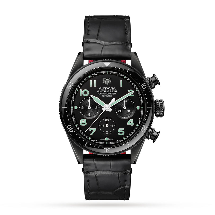 The TAG Heuer Autavia Flyback Chronometer is a black automatic pilot’s watch with a chronograph dial, three subdials, white hands, and a black leather strap, featuring the calibre 02 Flyback movement. Shown on a white background.