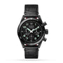The TAG Heuer Autavia Flyback Chronometer is a black automatic pilot’s watch with a chronograph dial, three subdials, white hands, and a black leather strap, featuring the calibre 02 Flyback movement. Shown on a white background.
