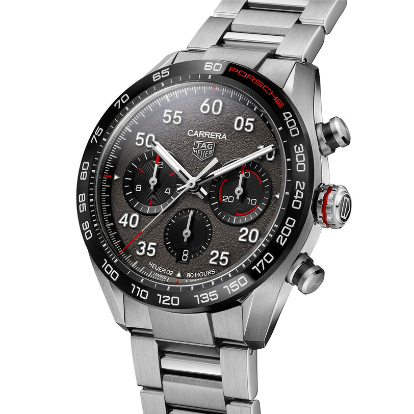 The TAG Heuer Special Edition Carrera Chronograph x Porsche features a stainless steel case, black bezel, textured dial with three subdials, and a metal link bracelet.