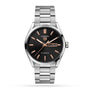A TAG Heuer Carrera Day-Date wristwatch in stainless steel features a black dial with rose gold markers and hands, day-date display at 3 o’clock, and is powered by a precision calibre 5 automatic movement.