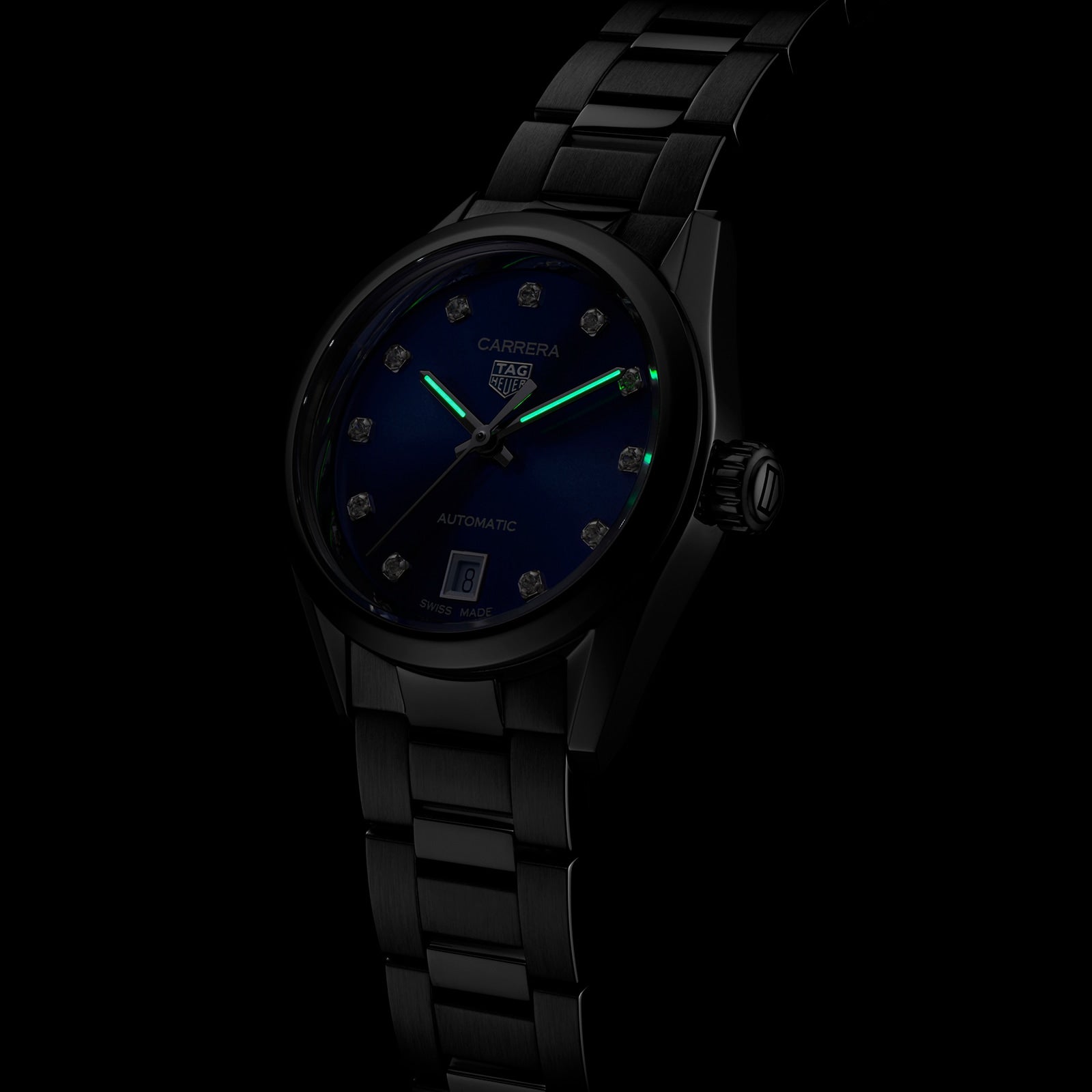A TAG Heuer Carrera Date automatic watch with a blue sunray dial, diamond hour markers, and luminous hands is set against a dark background.