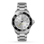 The TAG Heuer Aquaracer Professional 300 Date is a stainless steel diver’s watch with a silver dial, black bezel, date at 6 o’clock, silver bracelet, and automatic calibre 5, shown against a white background.