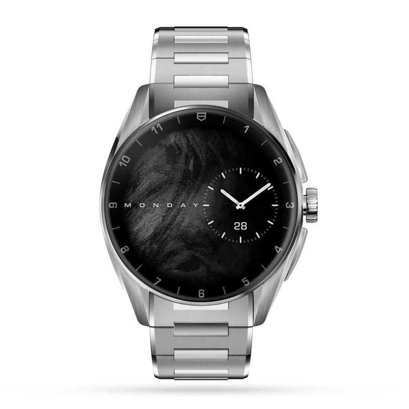 The TAG Heuer Connected Calibre E4 is a silver luxury smartwatch with a black marble face, showing Monday, the 28th, and a right-aligned analog subdial—an elegant showcase of cutting-edge technology.